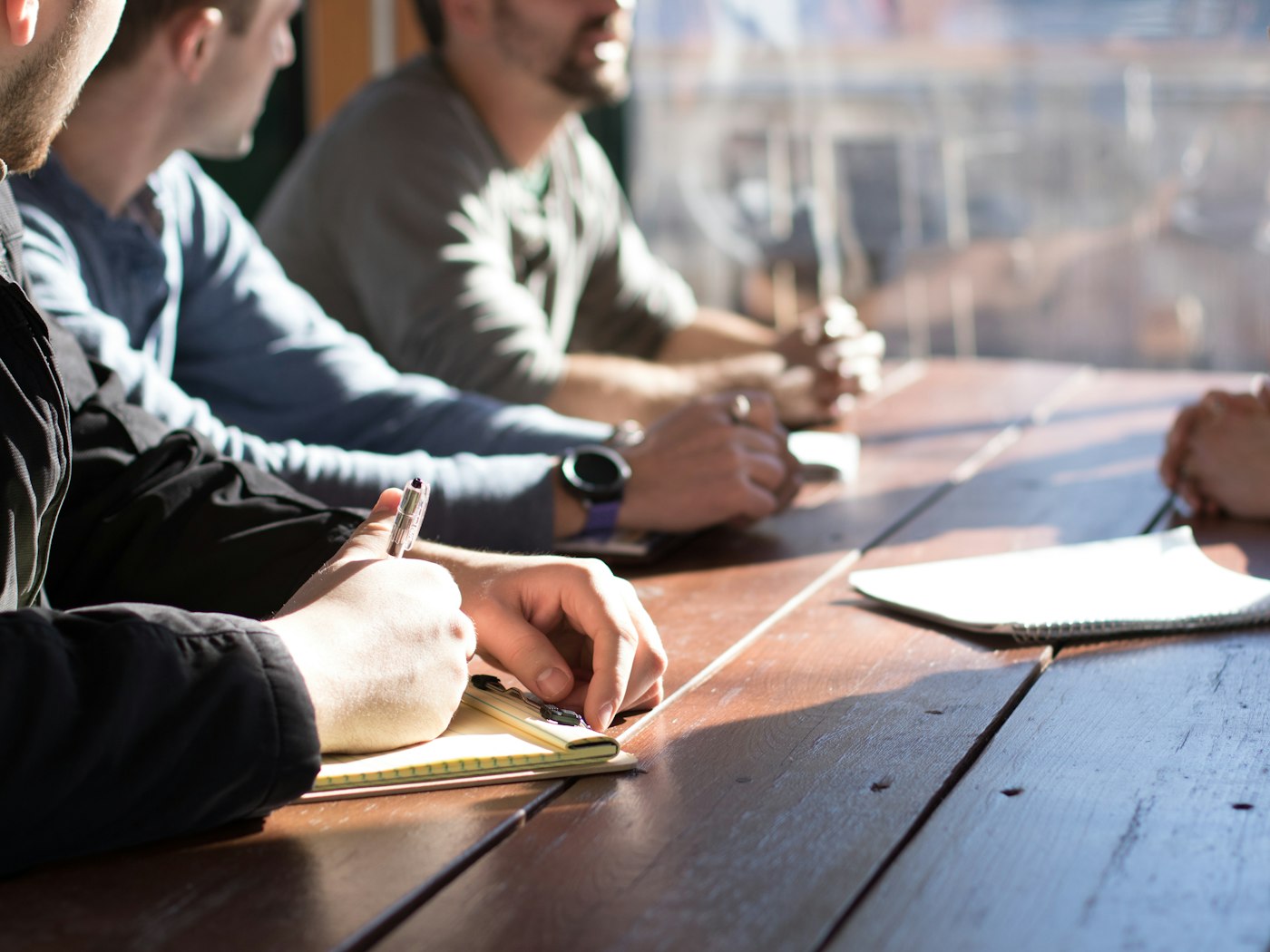 Team taking notes around a meeting table