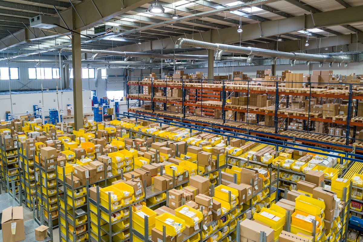 Large warehouse with stacked shelving and stock