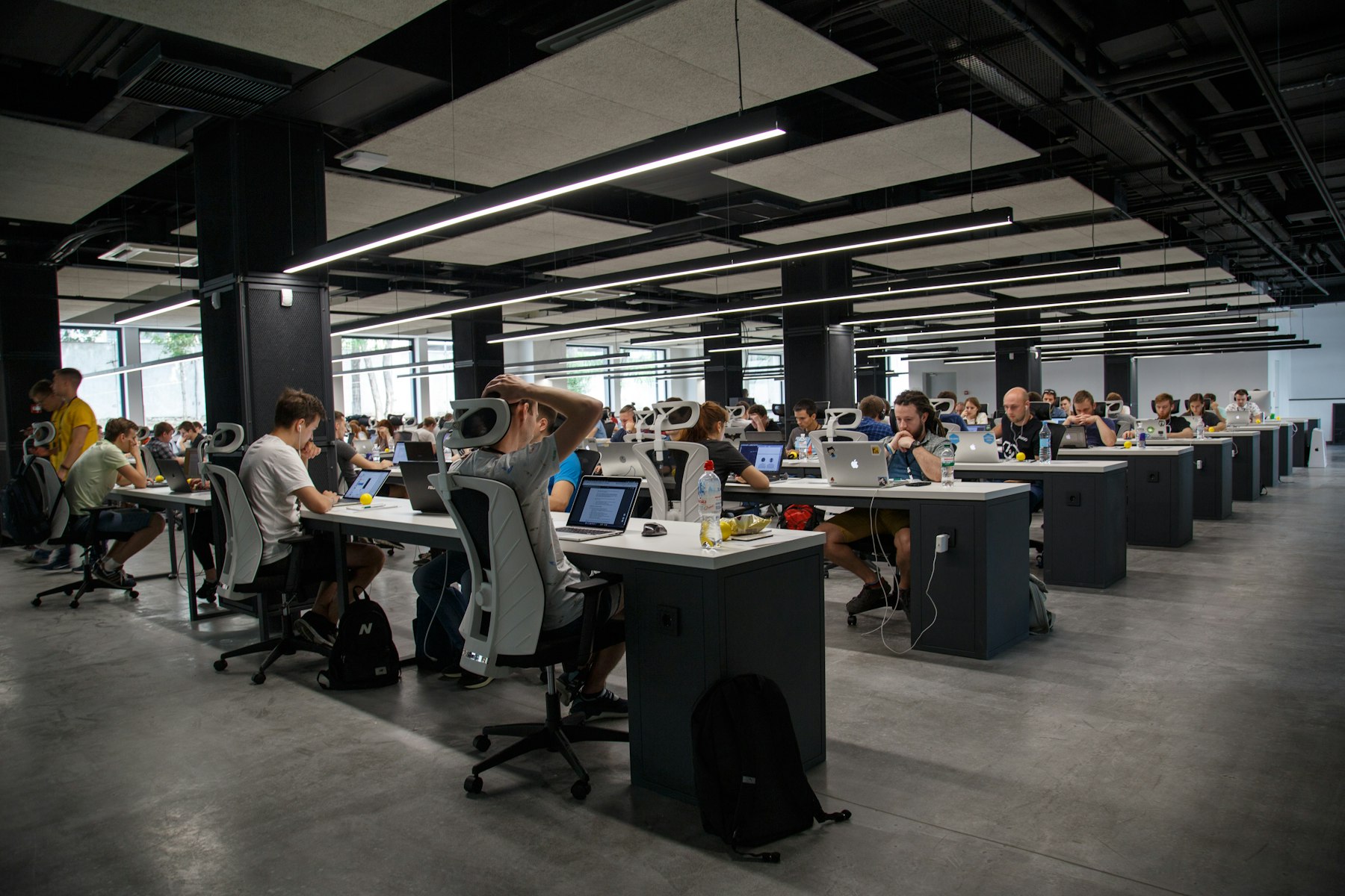Open-plan office with people working at long desks